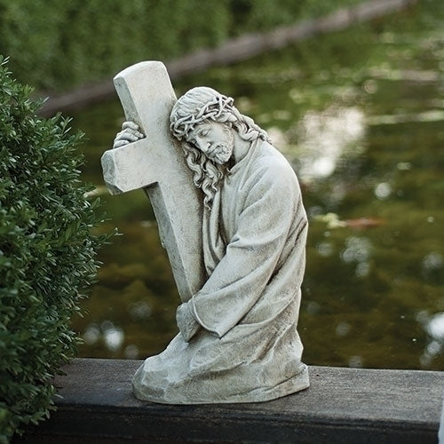 Jesus holding a cross garden statue